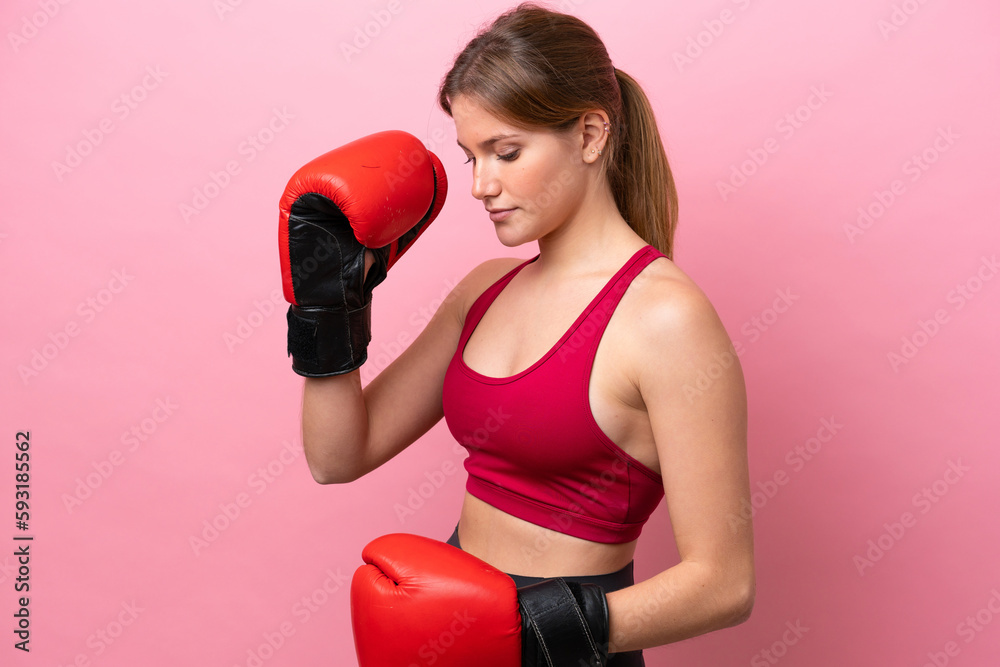 Young caucasian woman isolated on pink background with boxing gloves