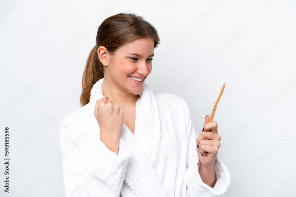 Young caucasian woman brushing teeth isolated on white background celebrating a victory Young caucasian woman brushing teeth isolated on white background celebrating a victory