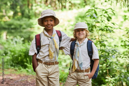 Portrait of two cute boy scouts looking at camera outdoors in forest while enjoying field trip © Seventyfour