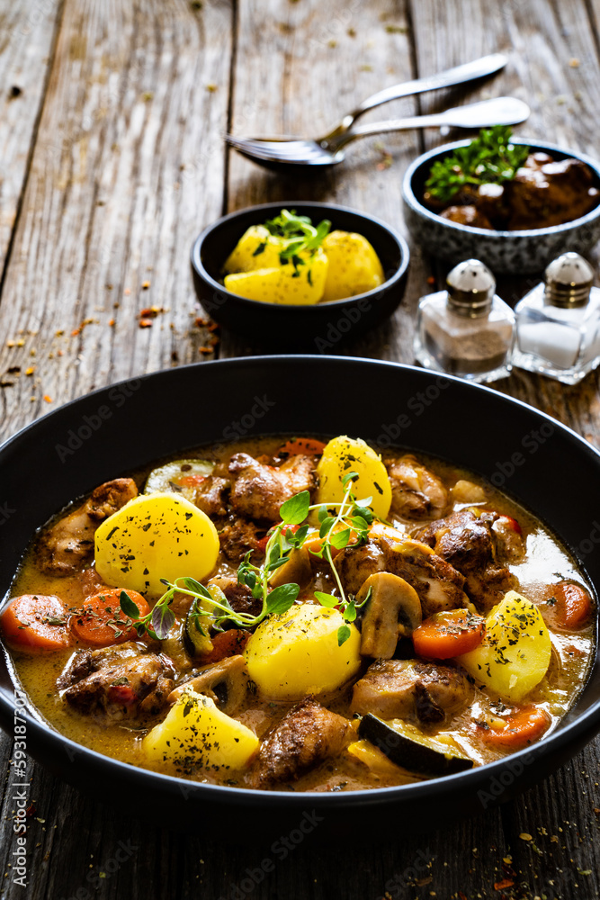 Delicious stew - cooked vegetables with roast meat on wooden table
Delicious stew - cooked vegetables with roast meat on wooden table