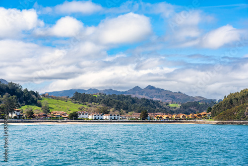 Tourist village by the sea and with high mountains in the background in the north of Spain, Ribadesella, Asturias.