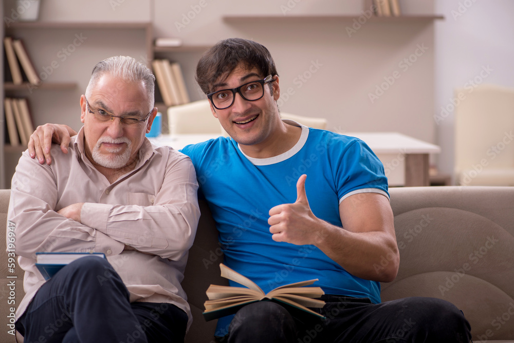 Young male student and his grandfather at home