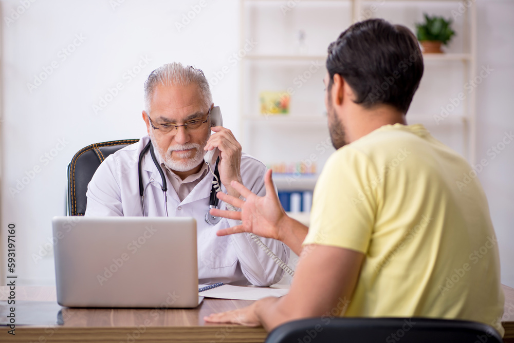 Young male patient visiting old male doctor Young male patient visiting old male doctor
