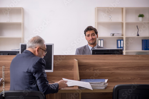 Two male colleagues working in the office