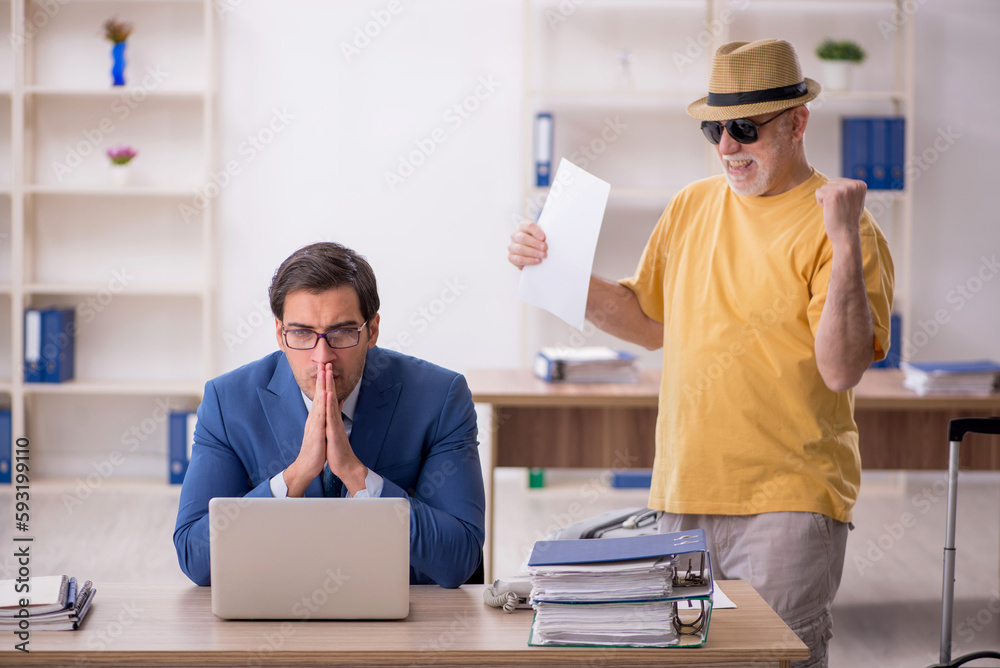 Old male boss and young male employee in summer vacation concept