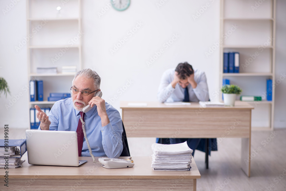 Two male colleagues working in the office Two male colleagues working in the office