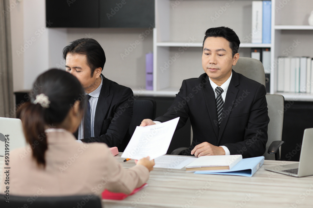 Human resources department managers sitting and interviewing female businesswoman applicant or candidate during job interview in modern office (Focus on female candidate). Business recruitment concept Human resources department managers sitting and interviewing female businesswoman applicant or candidate during job interview in modern office (Focus on female candidate). Business recruitment concept