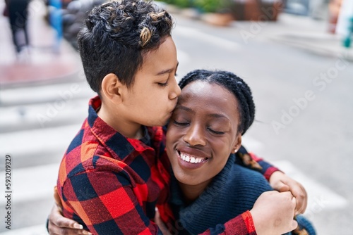 African american mother and son smiling confident hugging each other and kissing at street © Krakenimages.com
