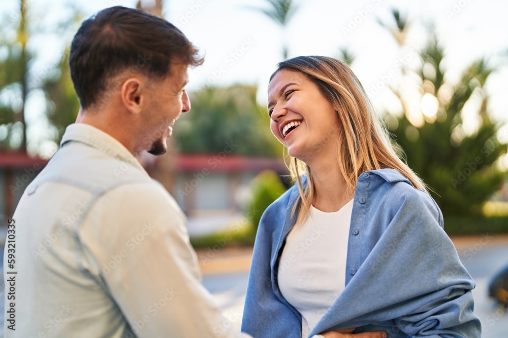 Fototapeta premium Young man and woman couple smiling confident standing together at street