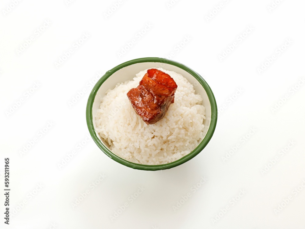 Close-up shot of steamed rice with pork belly in a bowl on white table Close-up shot of steamed rice with pork belly in a bowl on white table