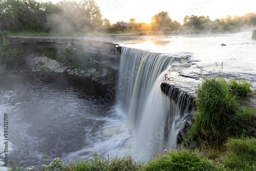 Beautiful scenery of the Jagala waterfall during a misty sunrise in Estonia