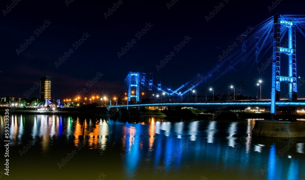 View of the Suspended Bridge Eng. Marcial Candioti on reflecting bokeh water in Argentina