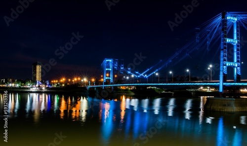 View of the Suspended Bridge Eng. Marcial Candioti on reflecting bokeh water in Argentina photo