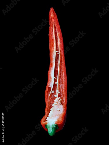 Closeup of a hot red pepper covered in water droplets, isolated on a black background