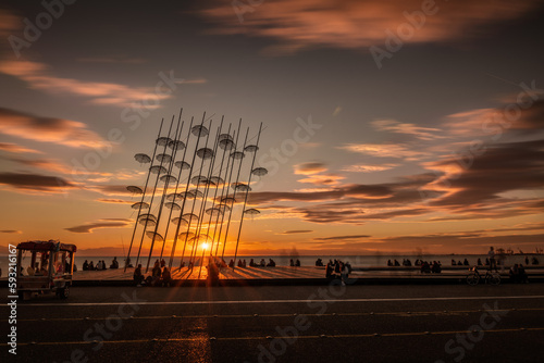 Beautiful sunset over the Zongolopoulos umbrellas and the beach in Thessaloniki, Greece.