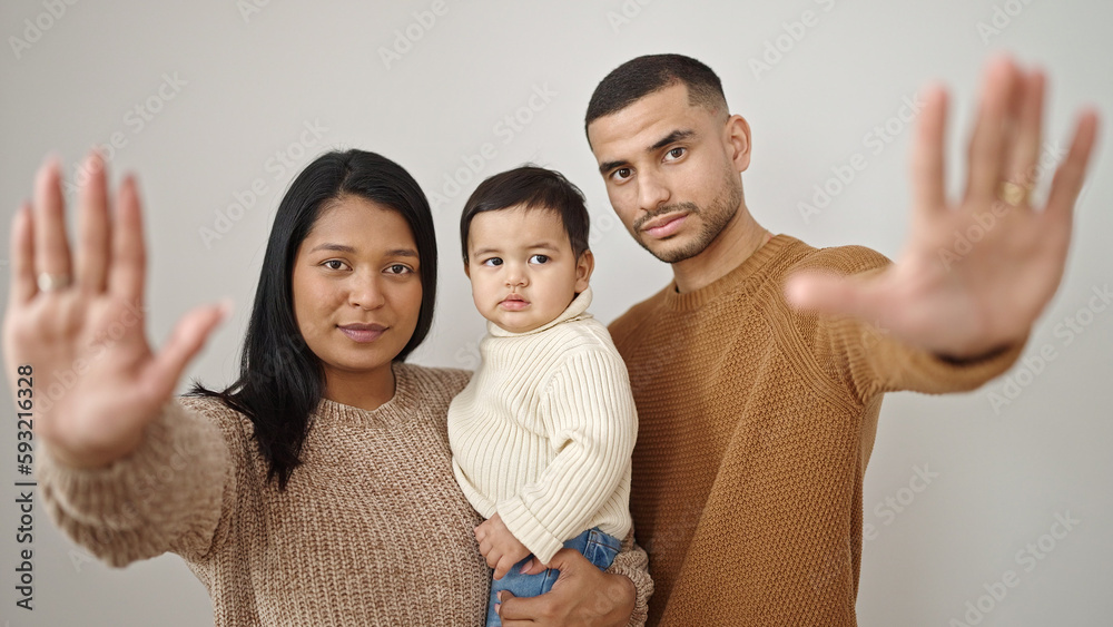 Couple and son hugging each other doing stop gesture over isolated white background Couple and son hugging each other doing stop gesture over isolated white background