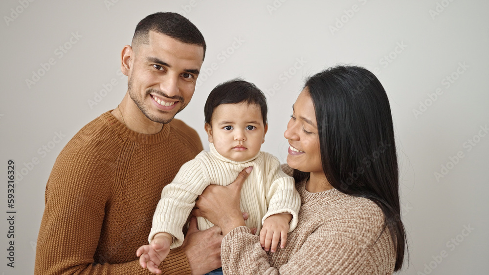 Couple and son hugging each other standing over isolated white background Couple and son hugging each other standing over isolated white background