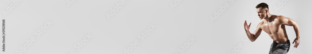 Confident muscular man with perfect torso running against white background
