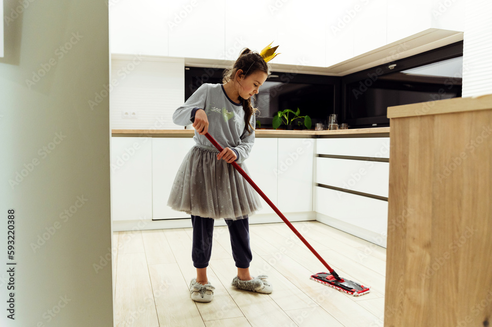 little daughter collects the kitchen. girl washes the floor in the kitchen. house helper. little housewife.House cleaning. daughter washes the floor little daughter collects the kitchen. girl washes the floor in the kitchen. house helper. little housewife.House cleaning. daughter washes the floor