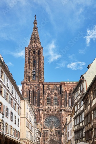 Vertical low angle shot of the historic Strasbourg Cathedral exterior against a blue sky in France
