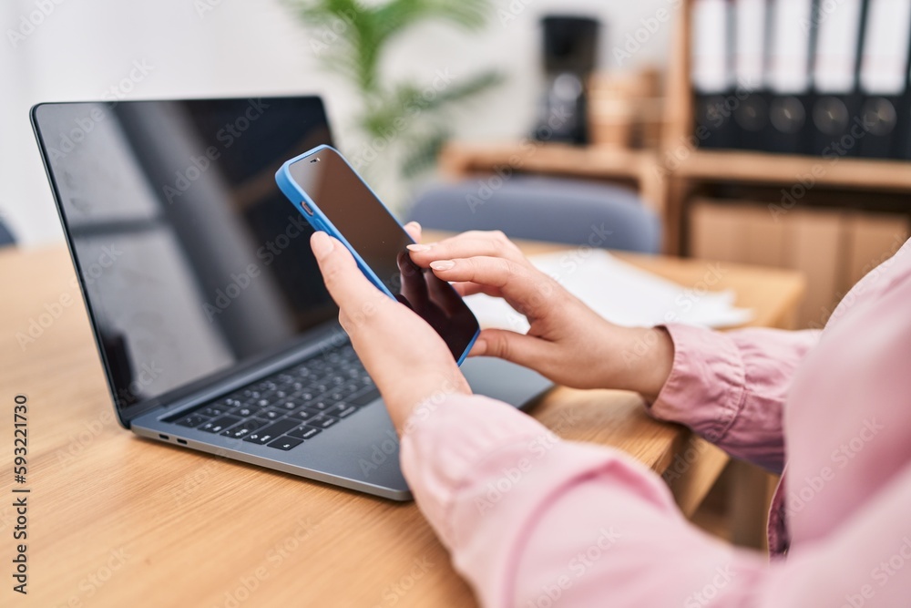 Young beautiful plus size woman using smartphone and laptop at office Young beautiful plus size woman using smartphone and laptop at office