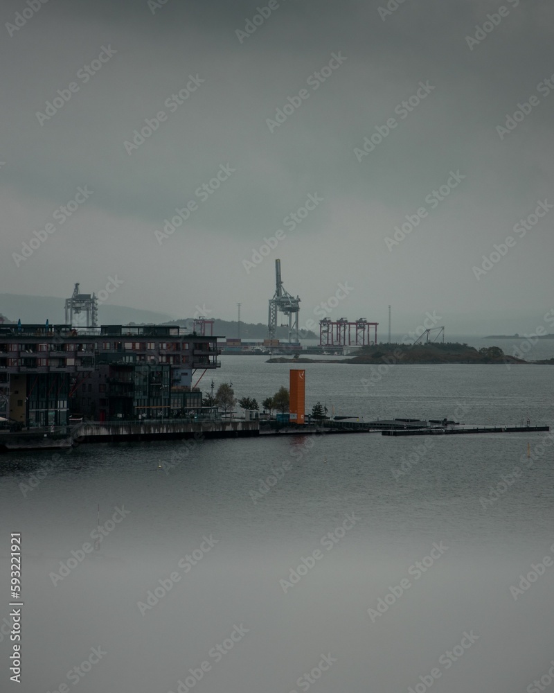 Vertical shot of a port with a cloudy sky in the background in  Oslo, Norway