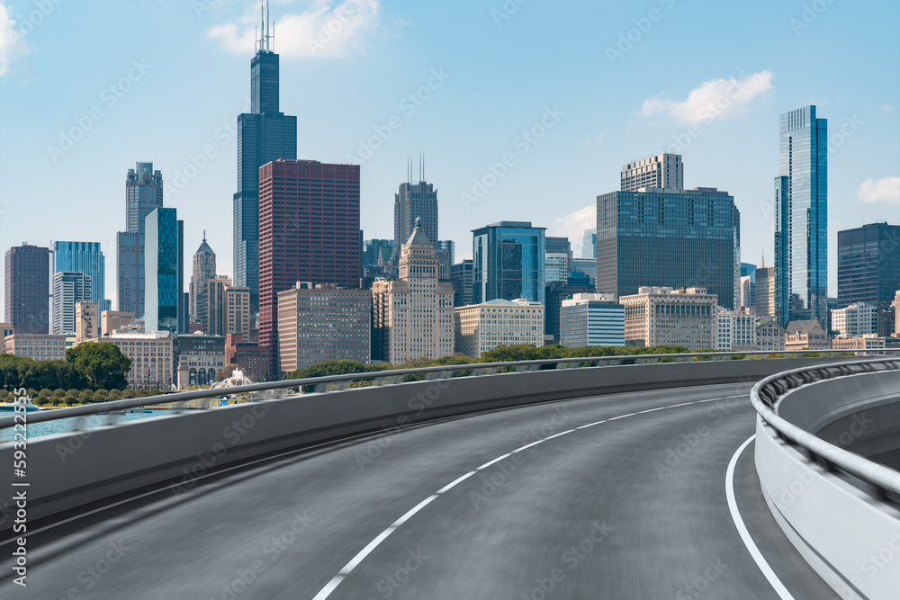 Empty urban asphalt road exterior with city buildings background. New modern highway concrete construction. Concept of way to success. Transportation logistic industry fast delivery. Chicago. USA. Empty urban asphalt road exterior with city buildings background. New modern highway concrete construction. Concept of way to success. Transportation logistic industry fast delivery. Chicago. USA.