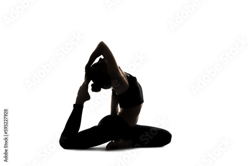 A woman doing yoga asana in front of a white background