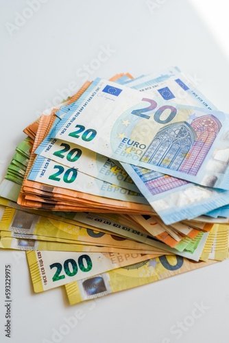 Closeup shot of Euro banknotes on a white table