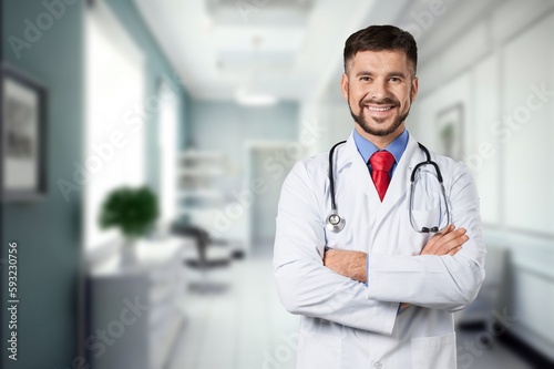 Portrait of happy doctor standing at hospital