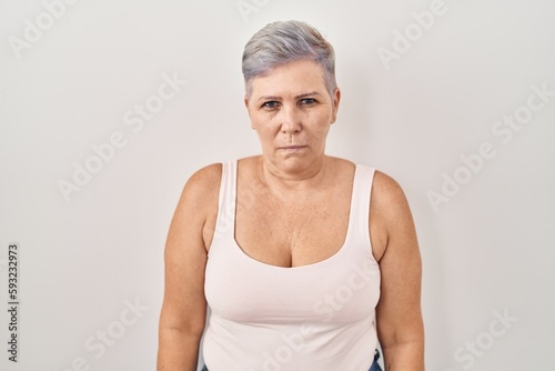 Middle age caucasian woman standing over white background skeptic and nervous, frowning upset because of problem. negative person.