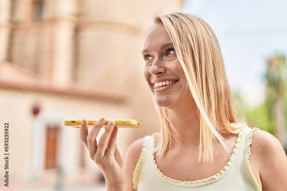 Young blonde woman smiling confident talking on the smartphone at street Young blonde woman smiling confident talking on the smartphone at street