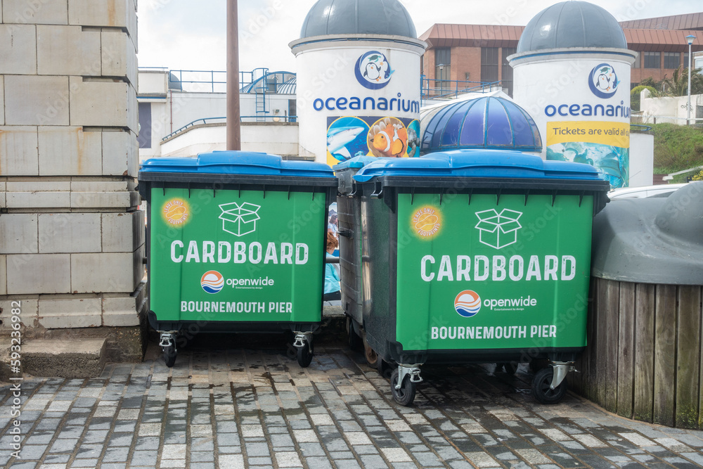 Large, black commercial wheelie bins on Bournemouth Pier for recycling