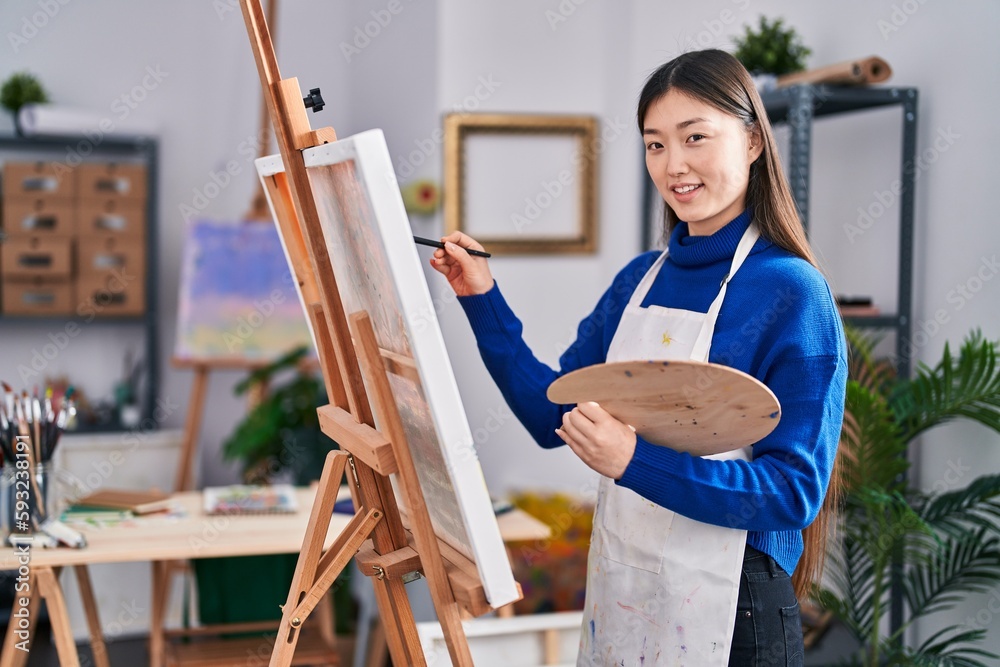 Fototapeta premium Chinese woman artist smiling confident drawing at art studio