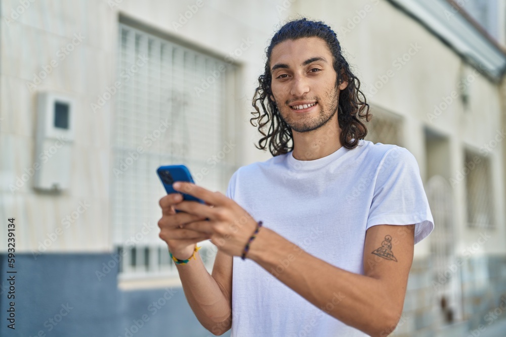 Young hispanic man smiling confident using smartphone at street Young hispanic man smiling confident using smartphone at street