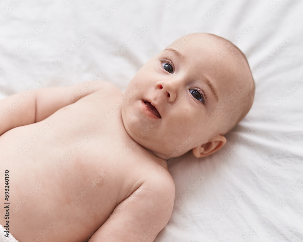 Adorable caucasian baby lying on bed at bedroom Adorable caucasian baby lying on bed at bedroom