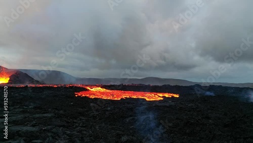 Lava flows from Mountain Fagradalsfjall. Aerial evening view, drone shot of lava spill out of the crater. Iceland, magma. photo