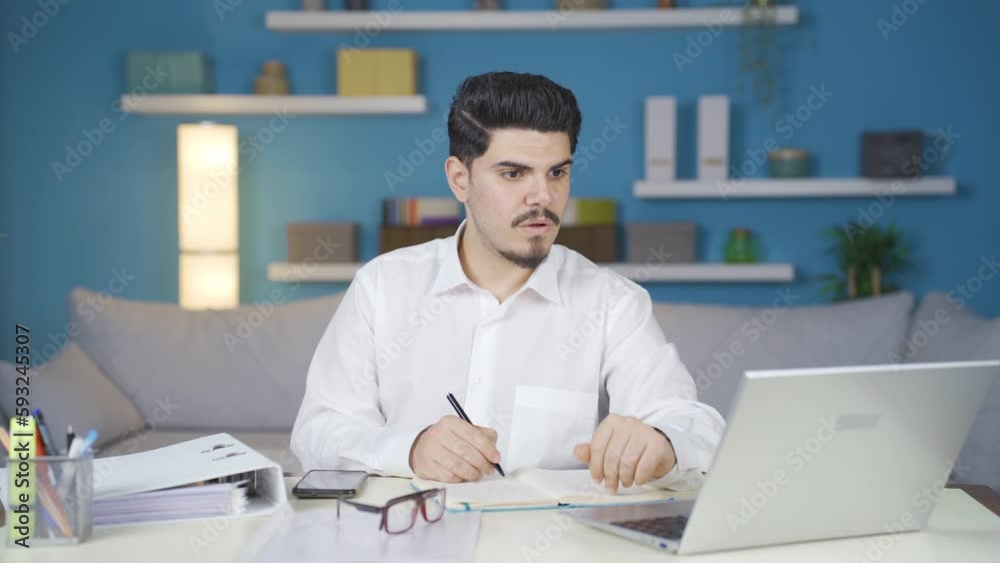 The man working from home is surprised by what he sees on the laptop and says wow. The man working from home is surprised by what he sees on the laptop and says wow.
