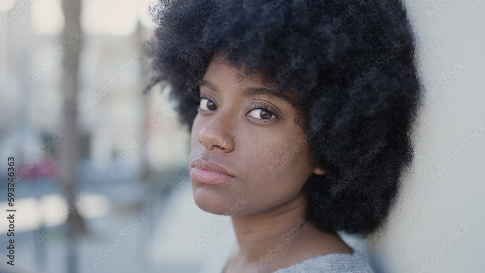 African american woman standing with sad expression at street African american woman standing with sad expression at street