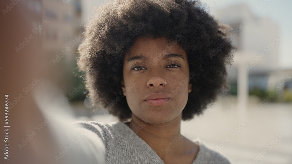 African american woman making selfie by camera with relaxed expression at street African american woman making selfie by camera with relaxed expression at street