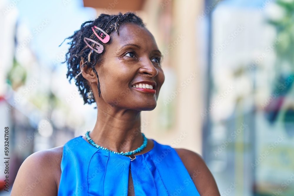 Middle age african american woman smiling confident looking to the side at street