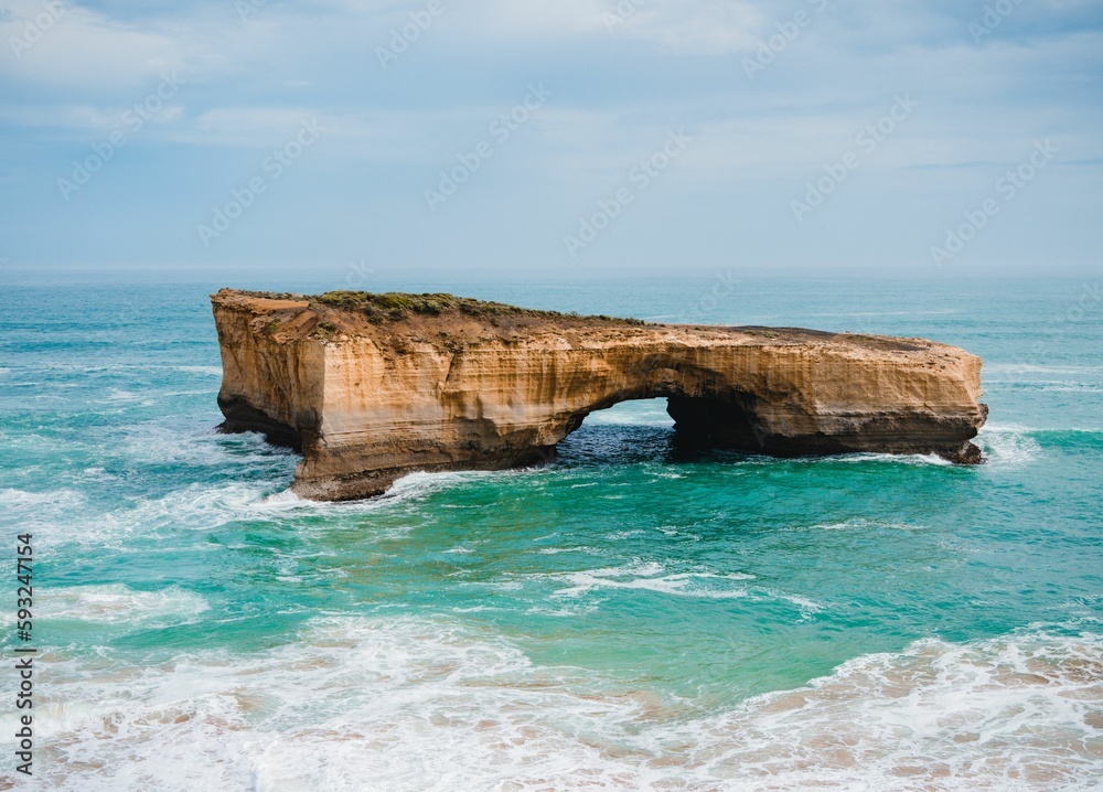 Drone view of the turquoise sea with a natural London arch in Port Campbell National Park, Australia Drone view of the turquoise sea with a natural London arch in Port Campbell National Park, Australia