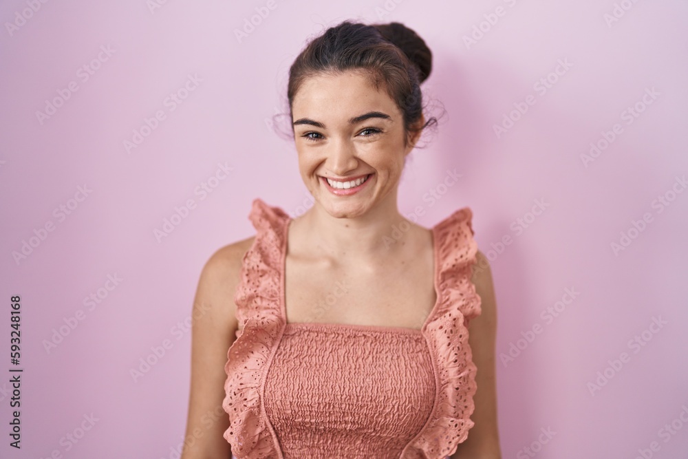 Young teenager girl standing over pink background with a happy and cool smile on face. lucky person. Young teenager girl standing over pink background with a happy and cool smile on face. lucky person.