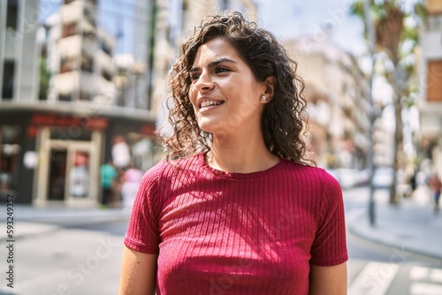 Young latin woman smiling confident standing at street © Krakenimages.com