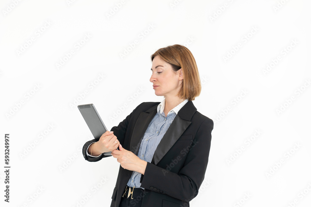 Young attractive business woman in black suit holding gadget isolated on white. Copy space and place for text concept