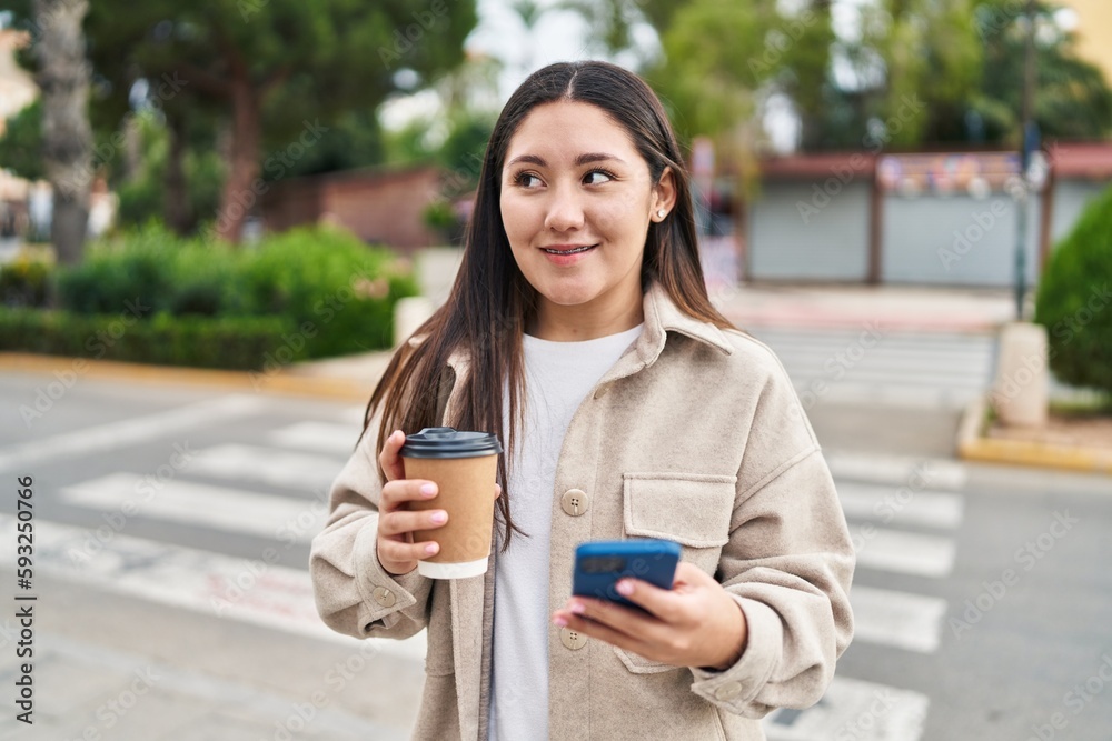 Young hispanic woman using smartphone drinking coffee at street Young hispanic woman using smartphone drinking coffee at street