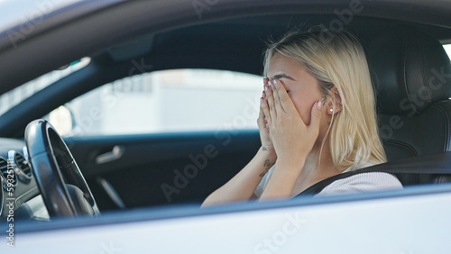 Young beautiful hispanic woman stressed driving car at street