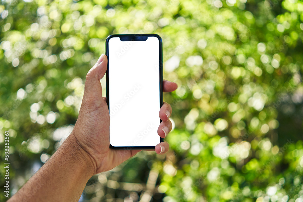 Man holding smartphone showing white blank screen at park Man holding smartphone showing white blank screen at park