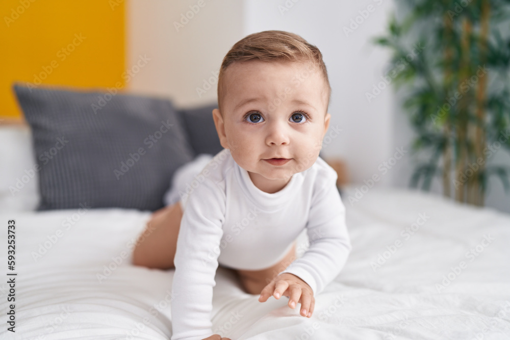 Adorable caucasian baby crawling on bed at bedroom Adorable caucasian baby crawling on bed at bedroom