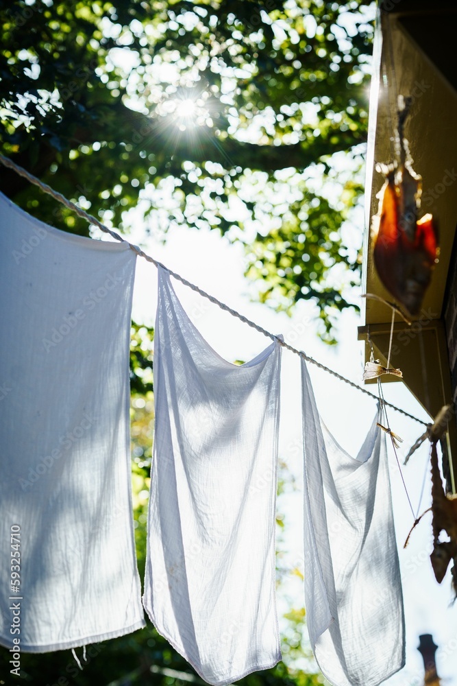 Laundry hangs in the sun on a wire Laundry hangs in the sun on a wire